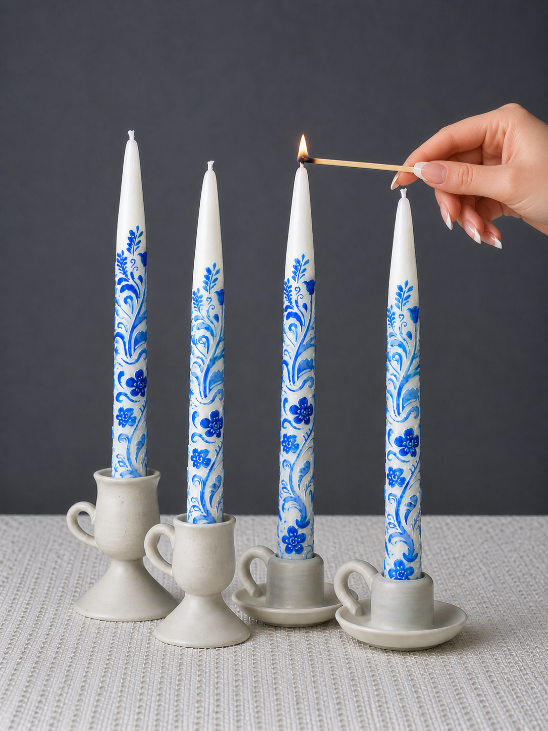 Lighting elegant blue and white taper candles for cozy dinner decor
